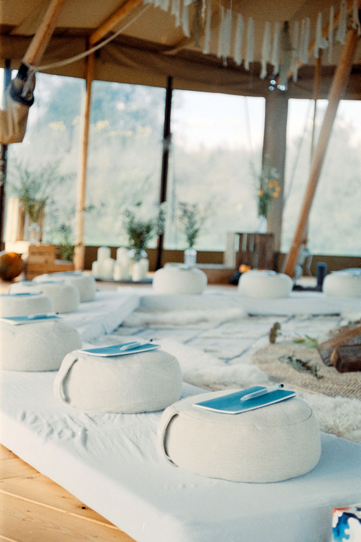Round cushions on white mats inside a light-filled dome.